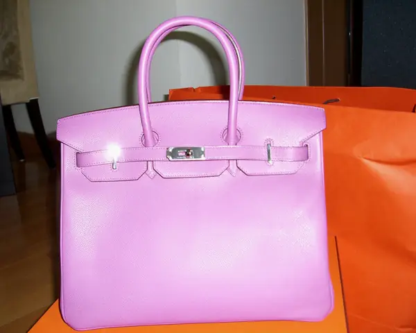 A pink Hermes Birkin with palladium hardware set on an orange Hermes box